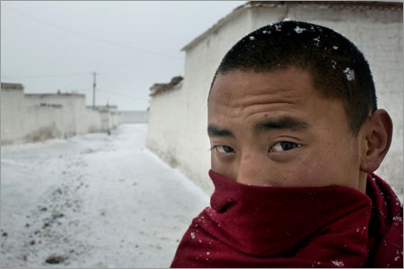 A monk stands in the snow at Amchok Monastery, where three Tibetans, including Tsering Dondhup, 35, recently self-immolated, in Amchok Village, Gansu Province, China on Dec. 17, 2012.