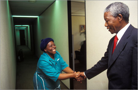 PW0073, South Africa, Johannesburg, 1994: Nelson Mandela greeting his staff members at his office. Goverment, ANC - African National Congress, famous people, puplic figures. Photograph: Paul Weinberg/ South Photographs