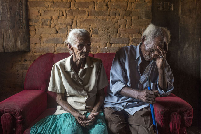 Severiana Maria de Jesus, 75, and her husband Pedro Jesus dos Santos, 89, who struggles with his painful glaucoma, in their home near Campo Alegre de Lourdes, in the state of Bahia, Brazil, on Saturday, Nov. 14, 2015. Although farming families receive a national anti-poverty cash welfare program, Bolsa Familia, they still suffer from chronic malnutrition, food shortages and limited access to water due to extreme poverty conditions. Their sitio, or homestead, received electricity just five-years-ago from the federal program, Luz Para Todos.